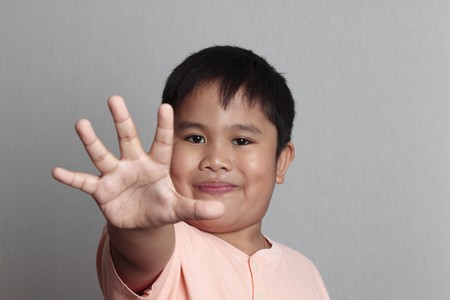 Boy in shirt acting stop concept for many uses.の写真素材