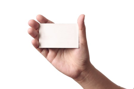 Blank business card in the hand of a woman in a white backgroundの写真素材