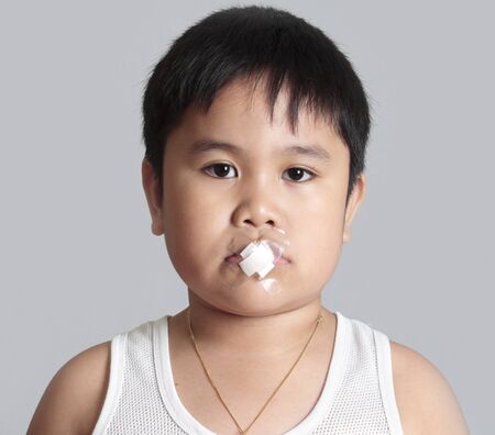 Banned to speak. A plaster on the mouth. の写真素材