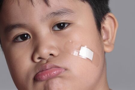 potraiture of a hurt boy with bandageの写真素材