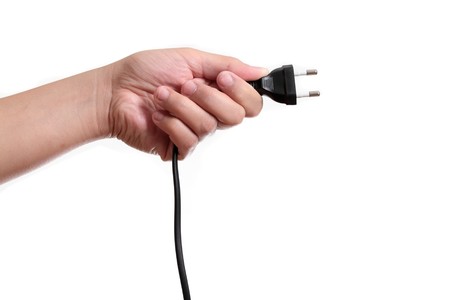 Woman holding black outlet in the hand isolated in white backgroundの写真素材