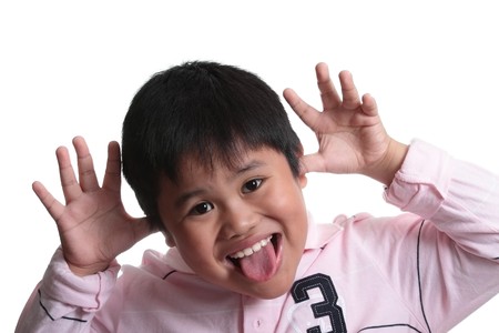 Child expressing surprise with his hands in his face の写真素材