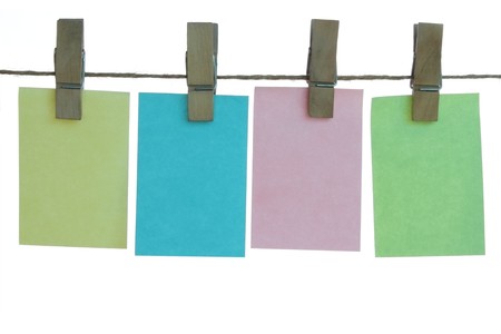 colored big paper notes hanging on rope (isolated on white background)の写真素材