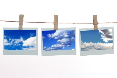 Polaroid templates hanged on a rope over white background の写真素材