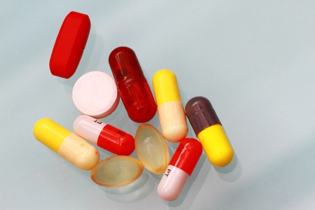 vitamins, pills and tablets with shadow and reflection