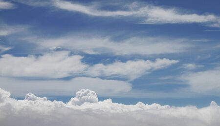 clouds within a clouds abstract- taken inside of airplane.