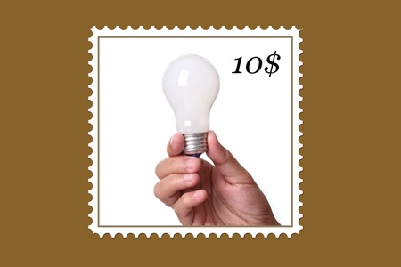 Lightbulb in a hand isolated on white background. 