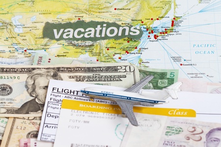 Airline boarding passes in a travel map with toy airplane.