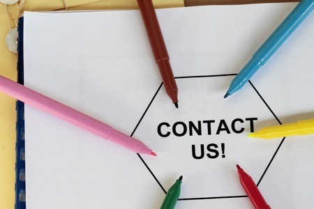 contact us written message on a folder with colored pen 