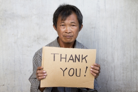 thank you message in a carton hold by an old manの写真素材