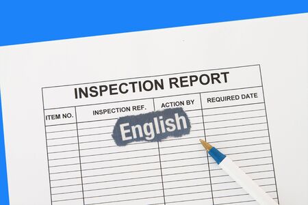 Inspection report with pen and english newspaper cutout の写真素材
