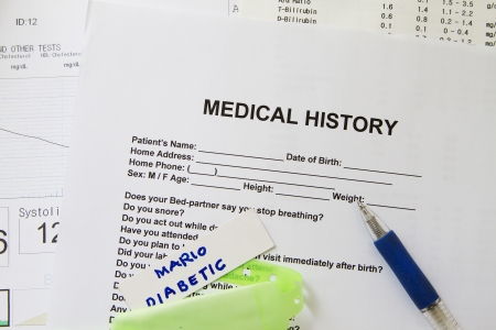 A medical history form with a green nametag の写真素材