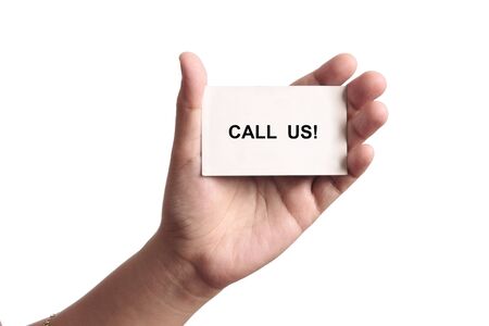 Call us card in the hand of a woman in a white backgroundの写真素材