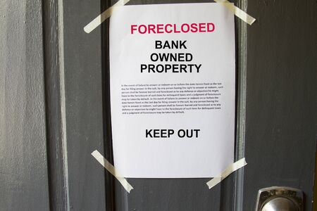 Foreclosed property notice taped on  a house door property.の写真素材