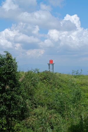 landscape view on the hill with blue sky and white clouds also orange watter torrentの写真素材