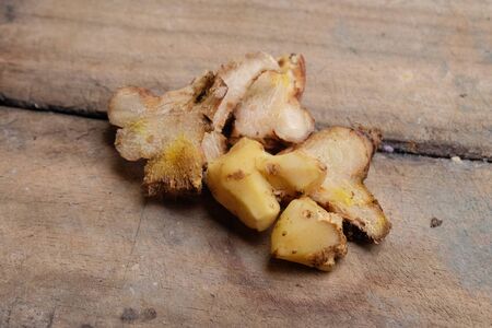Close up view of ginger and Alpinia Root lengkuas ginger or galangal on wooden cutting boardの写真素材