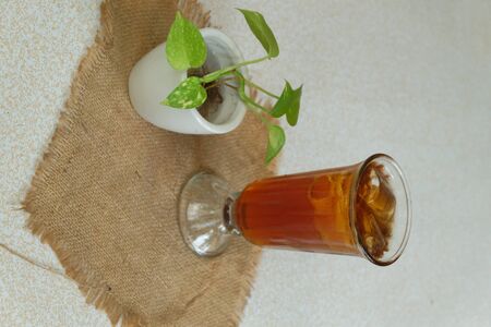 A glass of ice tea sits on a ramie fabricの写真素材