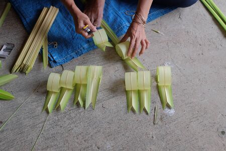 process of creating layur or penjor made from coconut leavesの写真素材