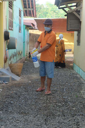 Purbalingga, Indonesia - Juli 31 2020: a man checking list of eidl adh contributors and workerのeditorial素材