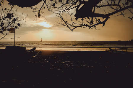 Silhouette boat and tree at sunset, cilacap, indonesia