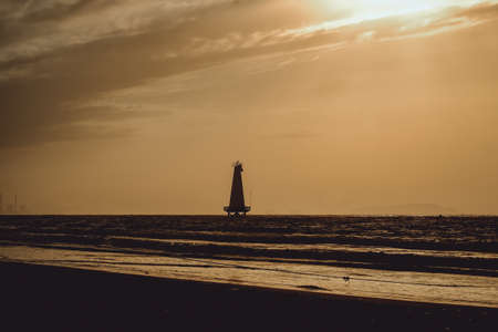 Silhouette lighthouse at sunset, cilacap, indonesia
