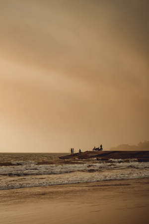 Cilacap, Indonesia - July 14 2020: sunset moment at Teluk Penyu Beach. People picnic and fishing in frameのeditorial素材