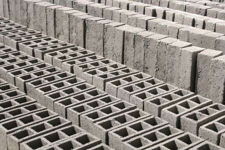 Concrete grey bricks drying in the sun in a brickyard in Cotacachi, Ecuador