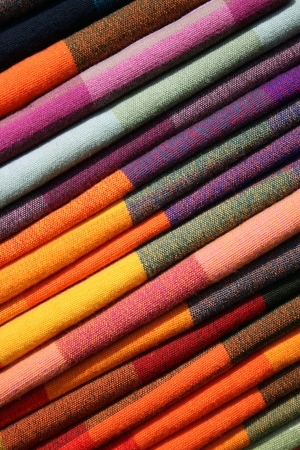 Stacks of tablecloths for sale at the outdoor craft market in Otavalo, Ecuadorの写真素材