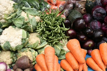 A vegetable stand with cauliflower, carrots, beans, cabbage, eggplant for sale at the outdoor vegetable market in Otavalo, Ecuadorの写真素材