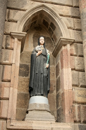 The statue of a Saint holding a skull in front of the Ibarra Cathedral in Ibarra, Ecuadorの写真素材