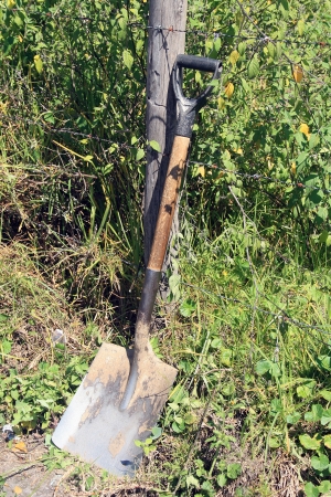 A shovel leaning against a farmers barbed wire fence in Cotacachi, Ecuadorの写真素材