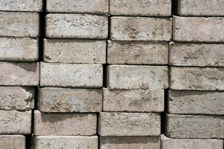 Stacked handmade gray bricks waiting for use at a construction site in Cotacachi, Ecuadorの写真素材