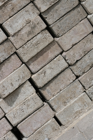 Stacked handmade gray bricks waiting for use at a construction site in Cotacachi, Ecuadorの写真素材