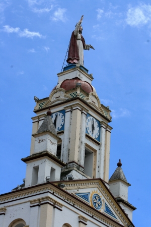 A statue of Christ on the top of the bell tower in the La Matriz Church in Cotacachi, Ecuadorの写真素材