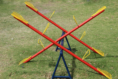 A yellow, red and blue teeter totter in a children\'s playground in Cotacachi, Ecuadorの写真素材