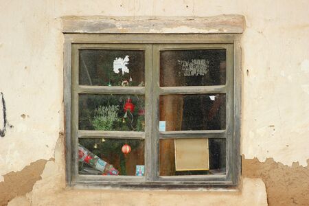 Glass windows in the wall of a building in Cotacachi, Ecuadorの写真素材