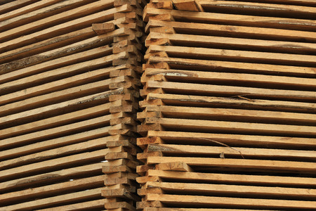 Fresh cut boards are stacked for sale at an outdoor lumber yard in Cotacachi Ecuadorの写真素材
