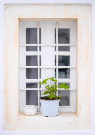 Beautiful old white window in Greeceの写真素材