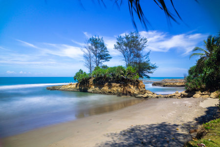 Tropical beach with palm trees and turquoise water in Sri Lankaの写真素材