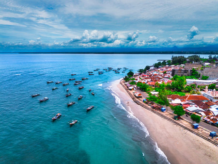 Natural view of Indonesian beach with white sand and blue sea on a clear morningの写真素材