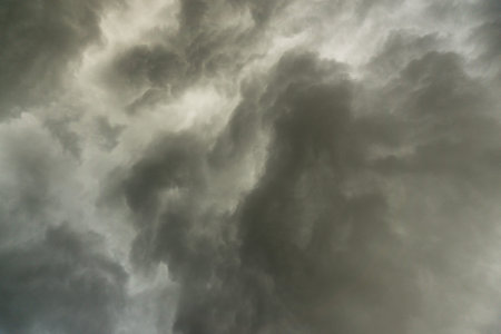 background photo of a stormy sky with rolling clouds and dark black