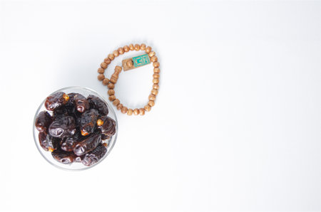 Glorious Dates and Prayer Beads on Brown To Represent Spiritual Reflection, often associated with Ramadan and spiritual growthの写真素材
