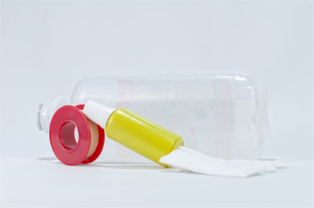 Medical Supplies Including Drip Water Bottle, Antiseptic drip, Tape and Bandage on White Backgroundの写真素材