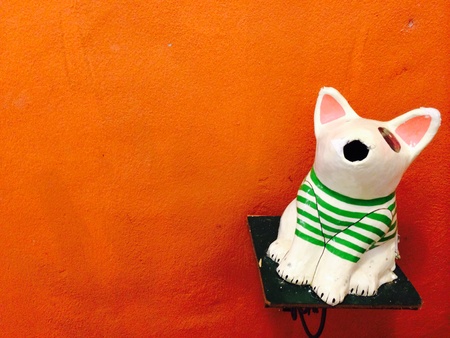 The dog doll at the orange backgroundの素材