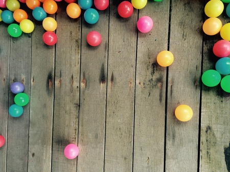 Colorful Ball rests on a wooden floorの素材