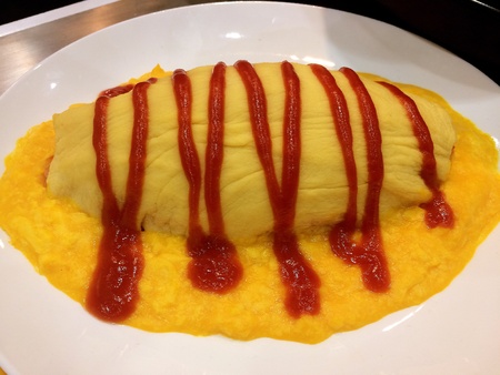 Omelet with tomato sauce in a beautiful dishの素材