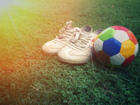 football and sport shoes on fieldの素材
