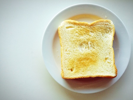 Bitter bang on the plate decorated with warm light,breakfast conceptの素材