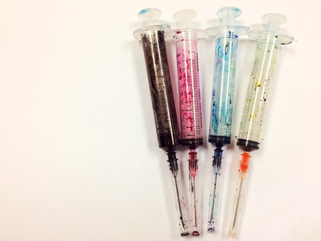 syringe for add ink to ink tank printer on white background with copy spaceの素材