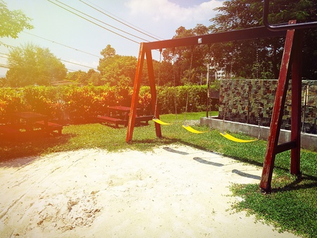 The playground has a large slider on sunshine dayの素材